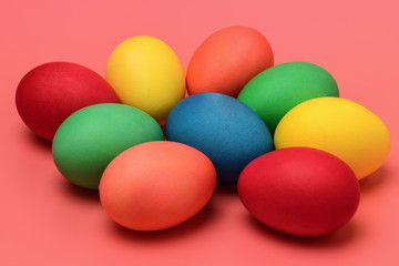 Colorful Easter eggs lie on a pink background. Horizontal photography.