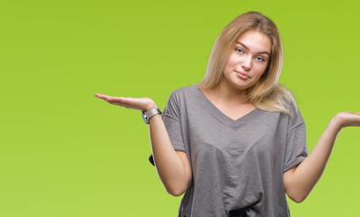 Young caucasian woman over isolated background clueless and confused expression with arms and hands...