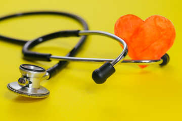 closeup view of stethoscope on yellow background