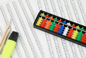 Abacus for mental arithmetic, against the background of examples to solve.