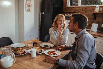 Adorable couple having breakfast