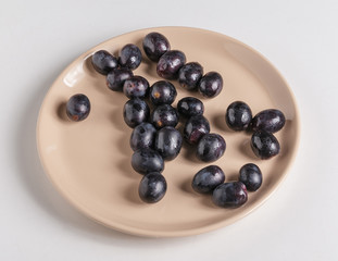 Black grapes on a plate.