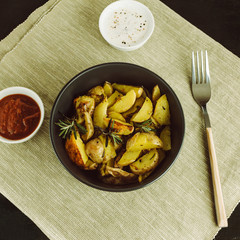 Baked potatoes with rosemary. Tomato and cream sauces. Top view.