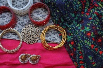 Indian decorations for dancing: bracelets, earrings for dancing bharatanatyam or kathak. Fabric background.