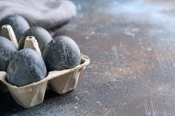 Blue eggs in cardboard packaging