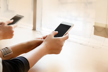 The hipster girl using mouile phone,touching on screen ,hipster hands texting mobile phone,blurry...