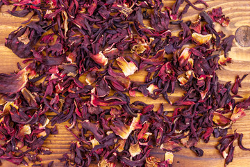 Dried hibiscus (carcade, roselle) on wooden table