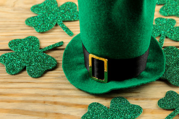 St.Patrick 's Day. celebration. Green cap of leprechaun and clover leaves on a natural wooden...