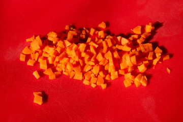 Food Background. Finely Chopped Carrot Over Red Background. Fresh Carrot.