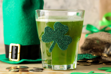 St.Patrick 's Day. celebration. green leprechaun hat and green beer, bow tie, coins and clover on a...