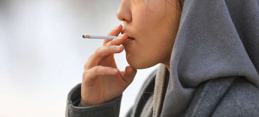 closeup portrait of a girl with a cigarette
