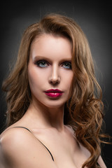 Fototapeta premium Close up portrait of a beautiful blonde girl model. Red lips and pink make up. Healthy clear skin
