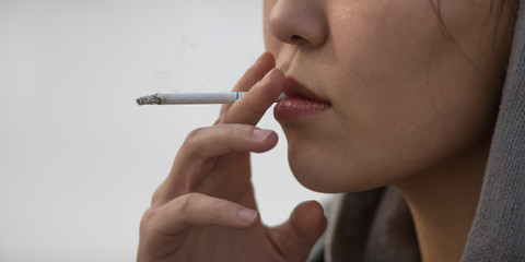 closeup portrait of a girl with a cigarette