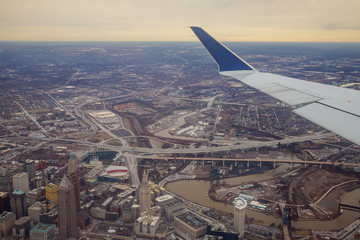 Panorama of Cleveland, Ohio from above with passenger plane going to land