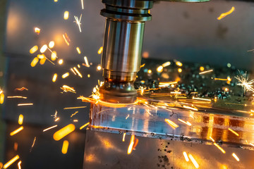 The  hot chip on CNC machine from tool wear. The CNC milling machine cutting the mold part with the index-able radius end mill tool in roughing process. © Pixel_B