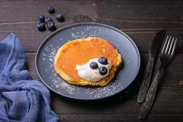 Pancakes with sour cream on a plate