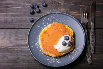 Pancakes with sour cream on a plate