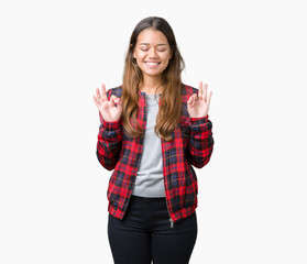 Young beautiful brunette woman wearing a jacket over isolated background relax and smiling with eyes closed doing meditation gesture with fingers. Yoga concept.