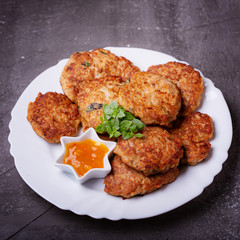 Homemade cutlets from minced fish with sauce