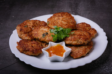 Homemade cutlets from minced fish with sauce