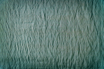 Texture of greenish crumpled fabric for background