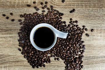 Coffee Cup and Coffee bean on wood table