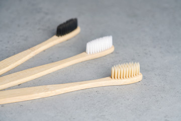 Ecological bamboo toothbrushes on concrete background