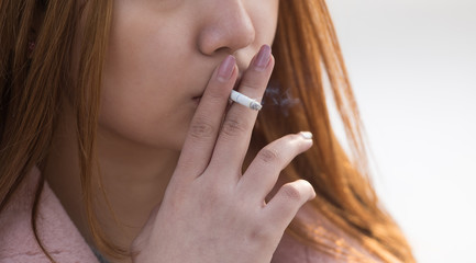 closeup portrait of a girl with a cigarette