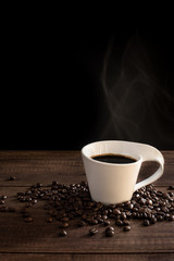 Coffee Cup and Coffee bean on wood table