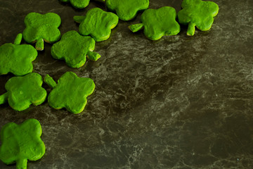 clover-shaped cookies on marble