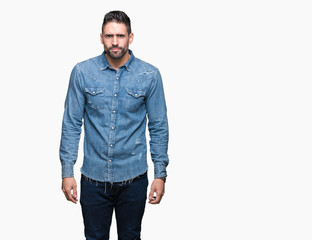 Fototapeta premium Young handsome man over isolated background skeptic and nervous, frowning upset because of problem. Negative person.
