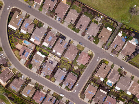 Aerial straight down view of streets and houses, many with solar panels in Folsom, California.