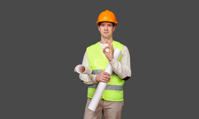 the civil engineer in a helmet shows gesture - OK, everything is good