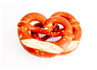 Two traditional Bavarian pastry Bretzes, beer snack. German salty bakery pretzel, isolated on white background.
