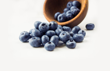 Sprinkled blueberries on white background. Ripe blueberries with copy space for text. Blueberry on a white background.