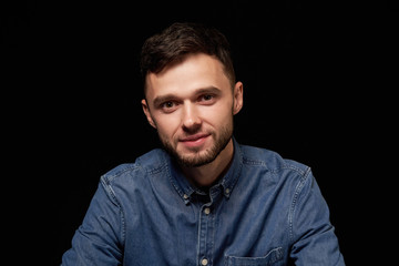 Fototapeta premium Handsome man in denim shirt looking at camera smiling