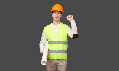 the civil engineer keeps a fist about a shoulder in a helmet, friendship gesture