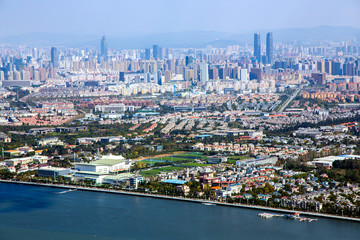 Fototapeta na wymiar Top view of the modern multi-million city of Kunming, China. Kunming is capital of Yunnan province , most famous city of southwest China and southeast Asian on the shore on the north shore of Dianchi 