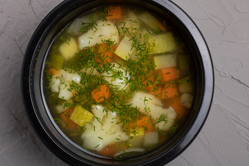 Bowl of homemade vegetable soup with potatoes, carrots, and parsley. Simple and healthy vegan meal,...