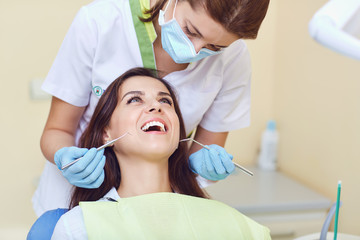 Obraz na płótnie Canvas A woman and a dentist in a dental clinic
