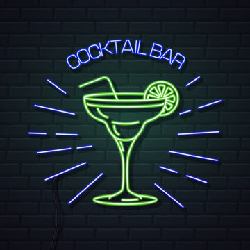 Neon sign cocktail bar on brick wall background. Vintage electric signboard.