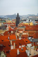 Obraz premium Top view over red roofs and historic center of city Prague, Czech Republic. City panorama