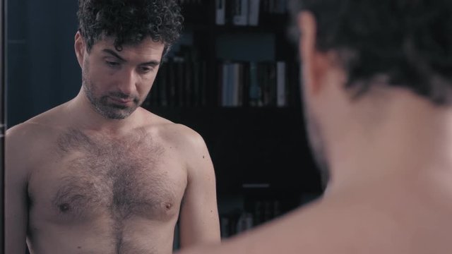 sexual problems of a couple.black woman comforting impotent husband at mirror