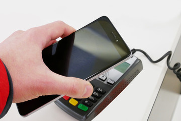Payment by smartphone, paying with NFC technology.
