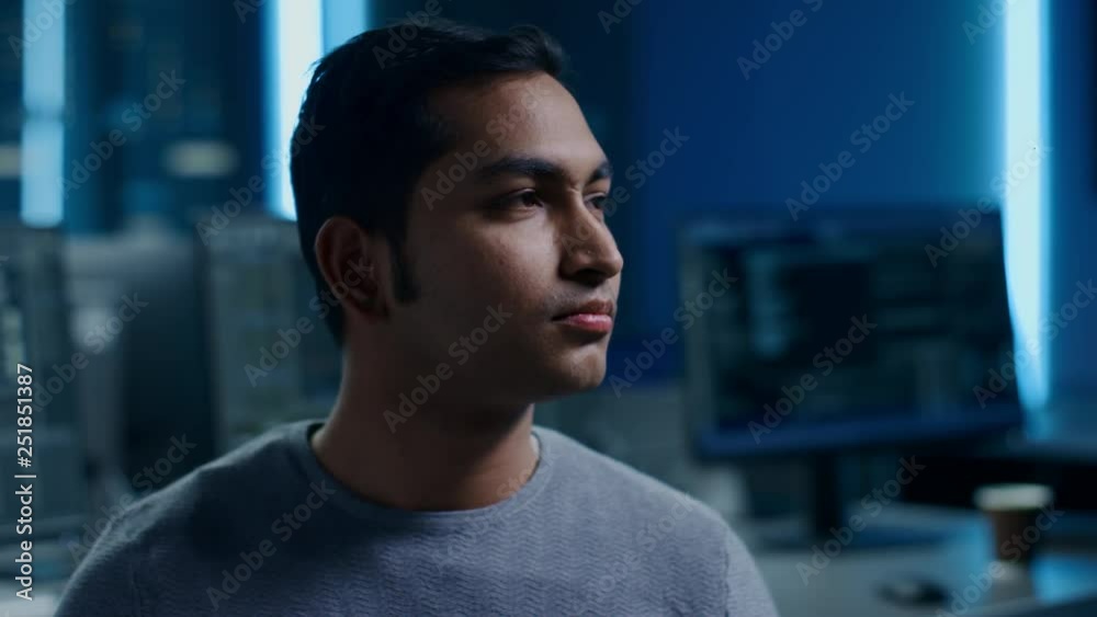 Aufkleber Portrait of Handsome Indian Software Developer Posing Calmly. In the Background Technologically Advanced Data Center with Multiple Computer Displays.