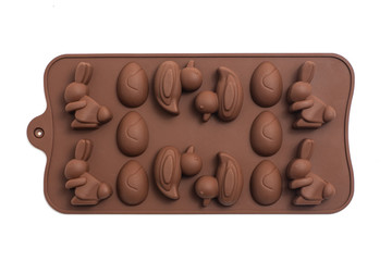 Brown silicone chocolate mold isolated on a white background. Rabbit, egg and duck
