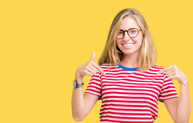 Beautiful young woman wearing glasses over isolated background looking confident with smile on...