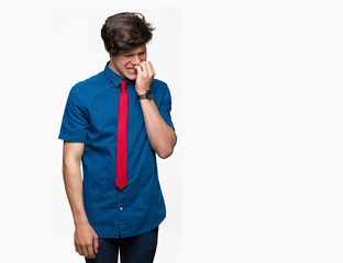 Young handsome business man wearing red tie over isolated background looking stressed and nervous with hands on mouth biting nails. Anxiety problem.