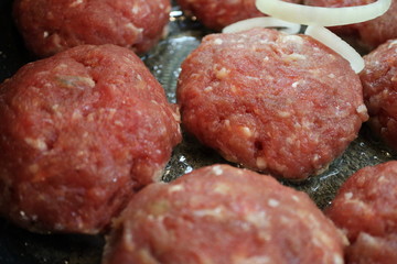 Cooking chops in a frying pan.