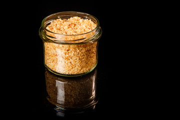 glass jar with yellow organic sea salt